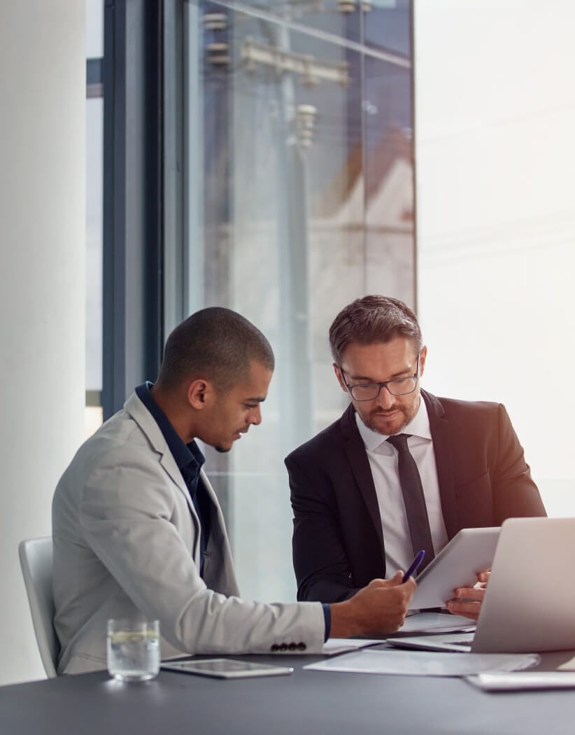 2 men working in a modern conference room