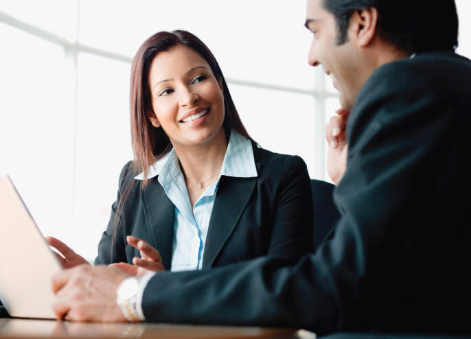 Business woman smiling to a business man