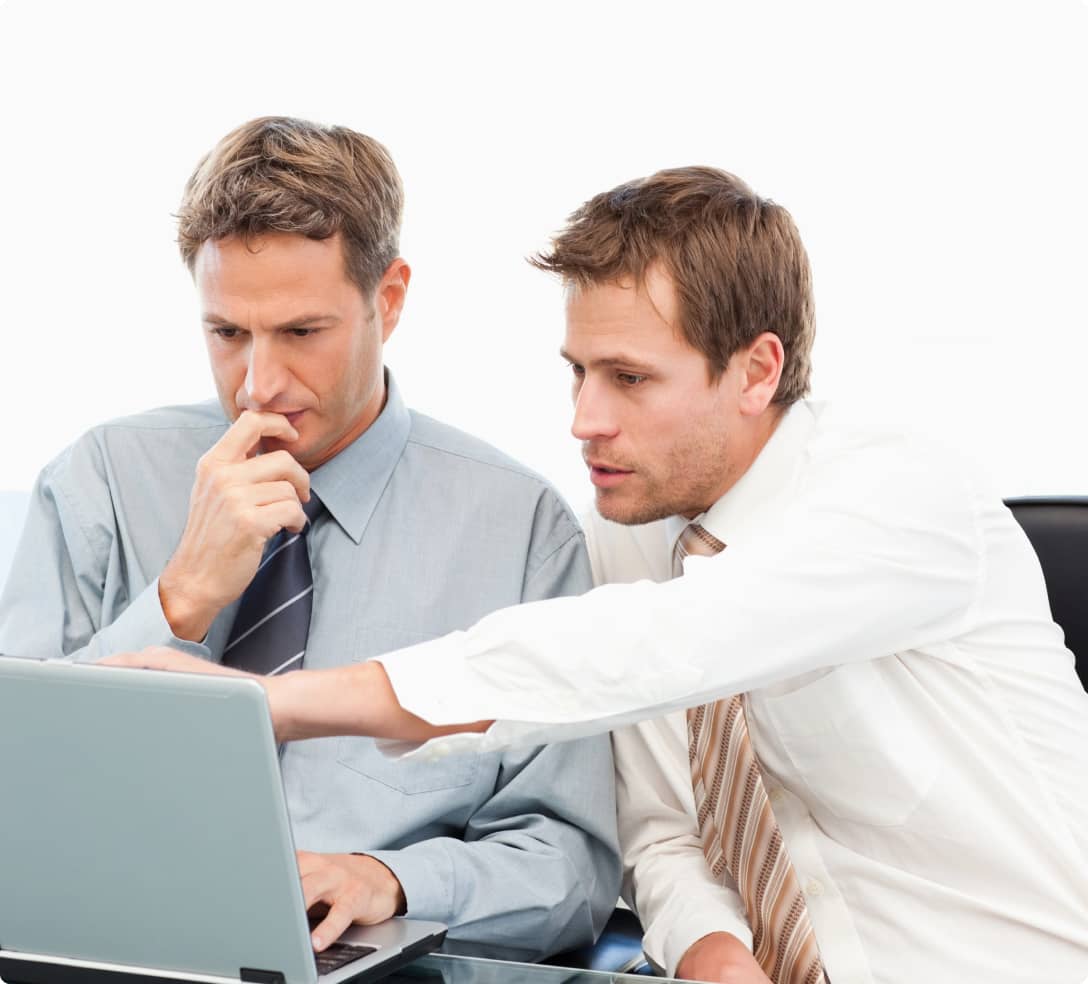 2 men thinking and acting in front of a computer