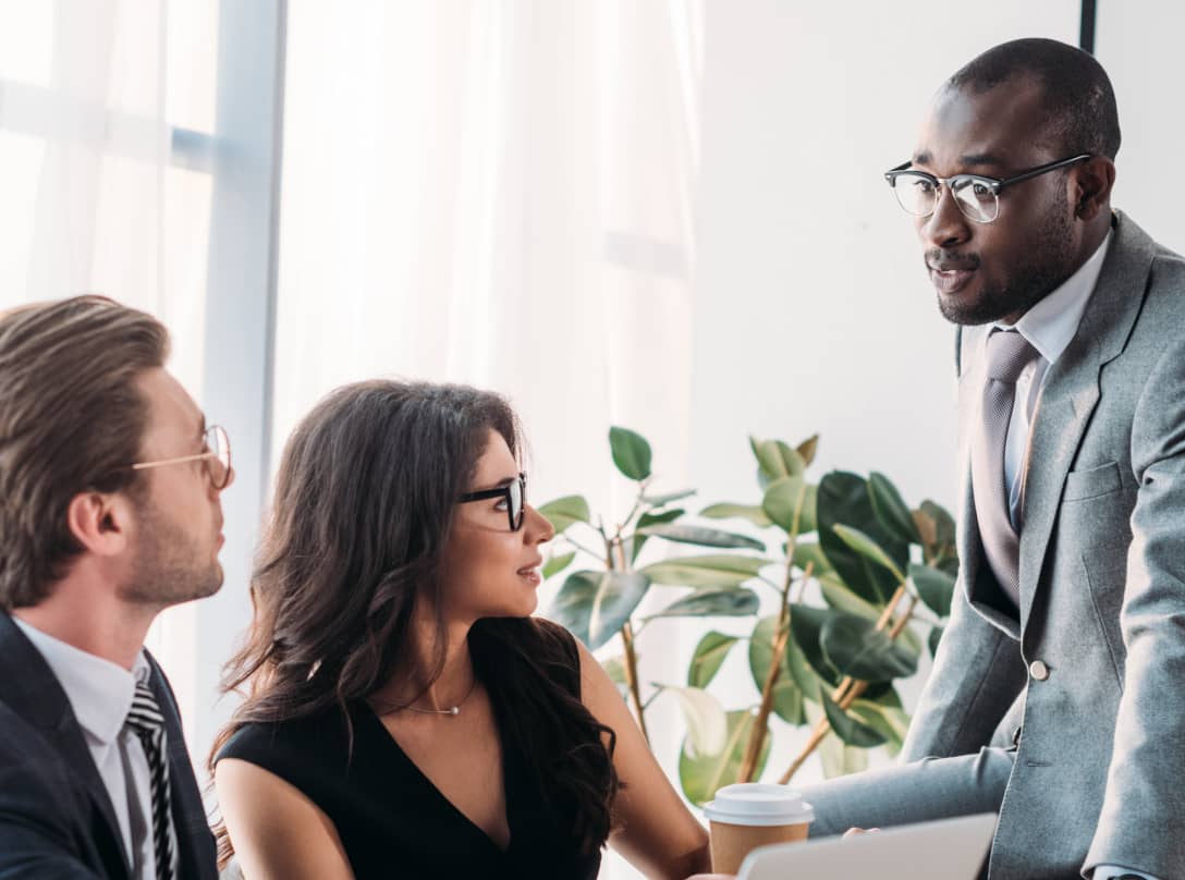 Man explaining something to his team in a conference room