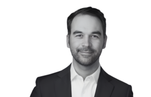 Cyber Threat Intelligence Senior Advisor A man in a suit, no tie, dark hair and a beard.