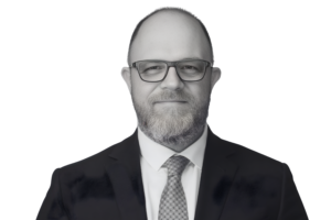 Cyber Threat Intelligence Director A man in a suit wearing glasses and a beard